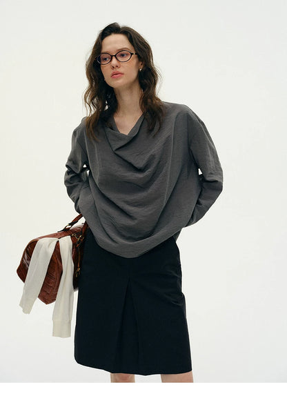 Front view of charcoal gray silk cowl neck top with black skirt