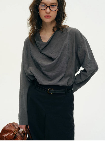 Close-up of charcoal gray silk top draped cowl neckline