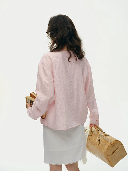 Back view of pink silk cowl neck top showing relaxed drape