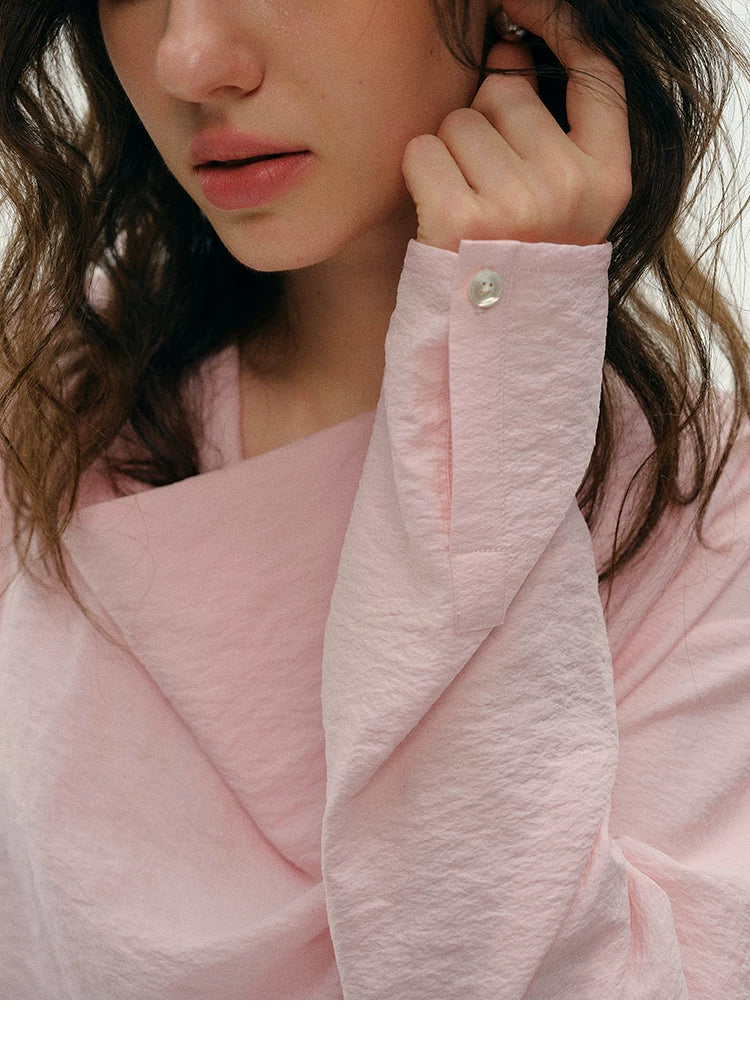 Close-up of pink silk top button cuff and sleeve detail