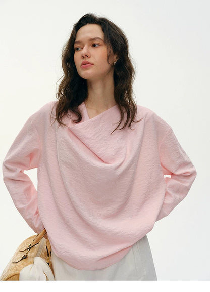 Close-up of pink silk top draped cowl neckline detail