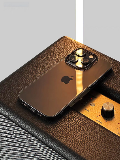 Clear black transparent phone case on iPhone placed on leather surface with warm lighting premium lifestyle scene