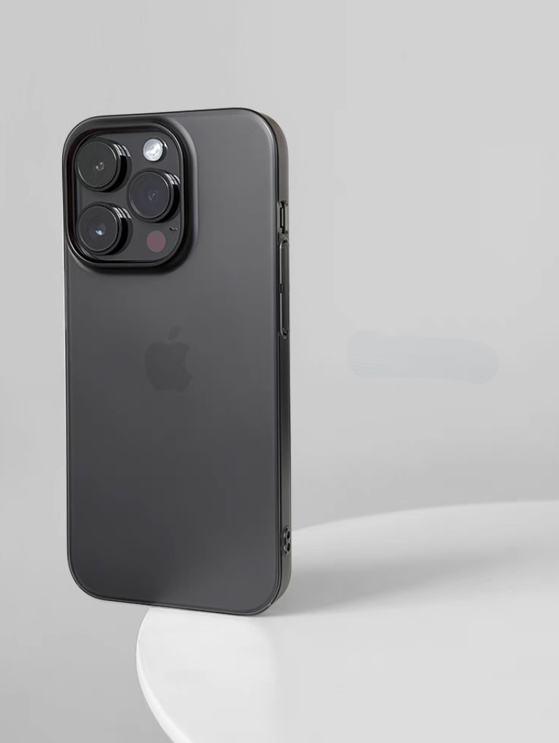 Matte black phone case on iPhone standing upright with smooth dark finish and minimalist style