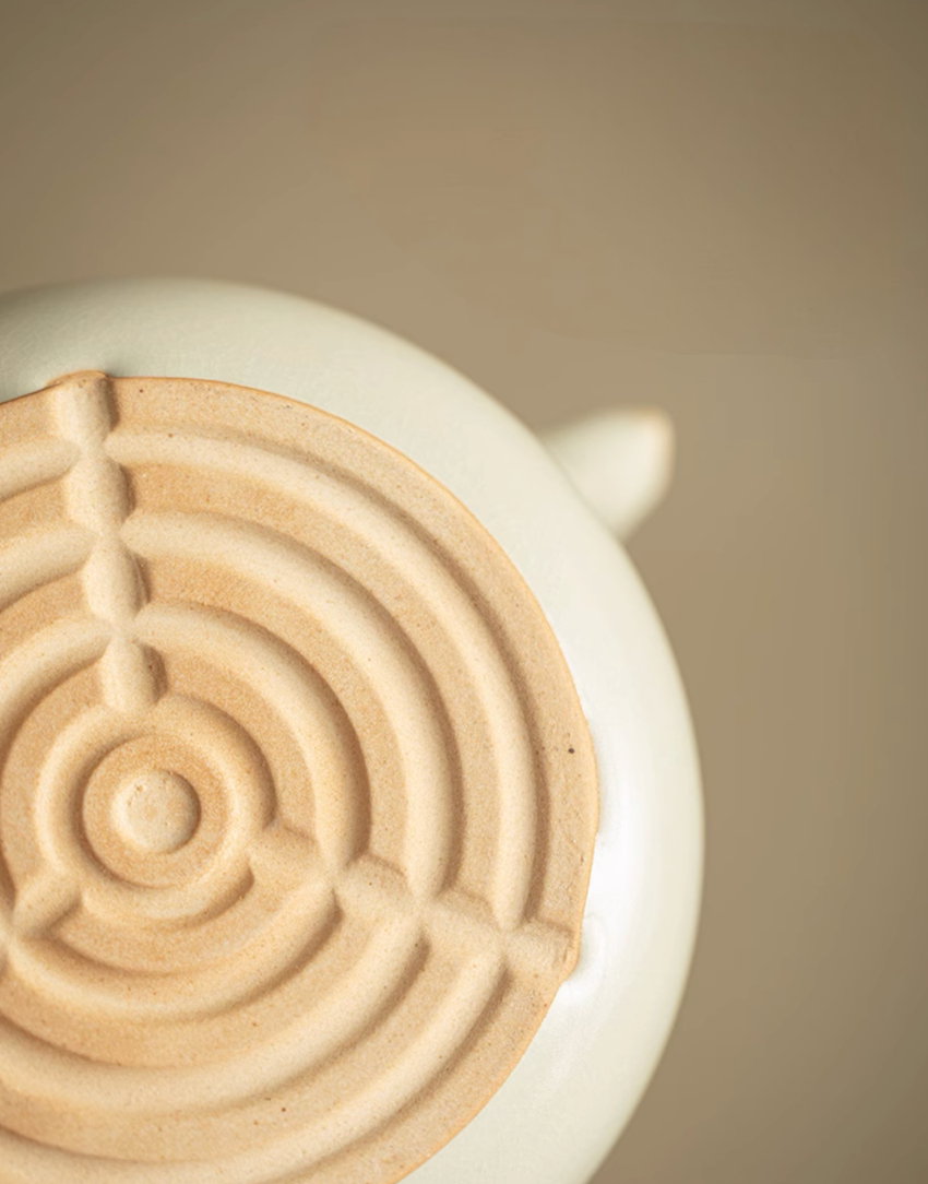 Bottom view of Soda Glaze Ceramic Teapot in off-white showing textured base design and natural clay finish