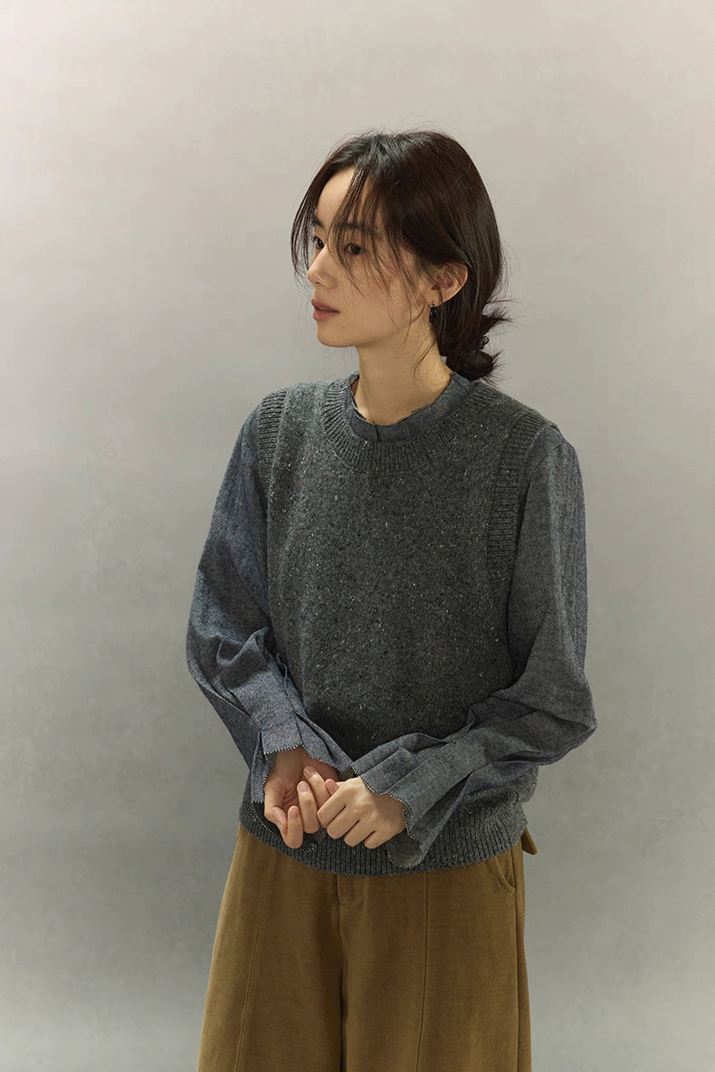 Model wearing speckled wool-blend knit vest in deep heather blue, side profile styling.