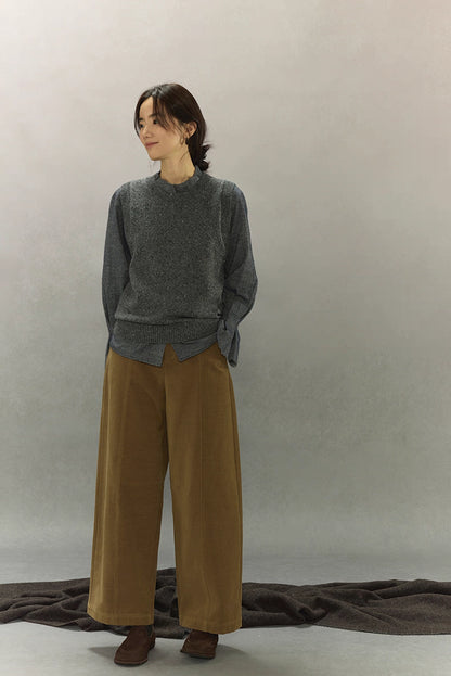 Full-body front styling of speckled wool-blend vest with relaxed trousers.