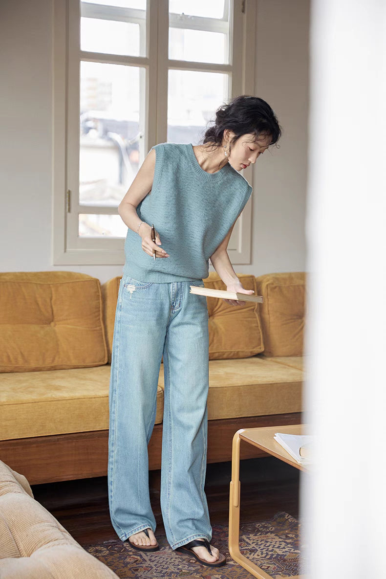 Full-body view of Lake Blue sleeveless merino vest paired with wide-leg jeans, emphasizing relaxed fit and lightweight knit for casual wear
