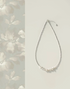 Soft white baroque pearl silver choker necklace full product view with delicate pearl cluster on white background