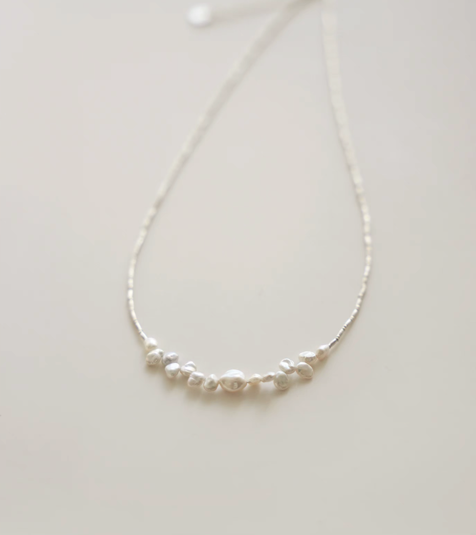 Close-up of soft white baroque pearl silver choker highlighting natural irregular pearl shapes and texture