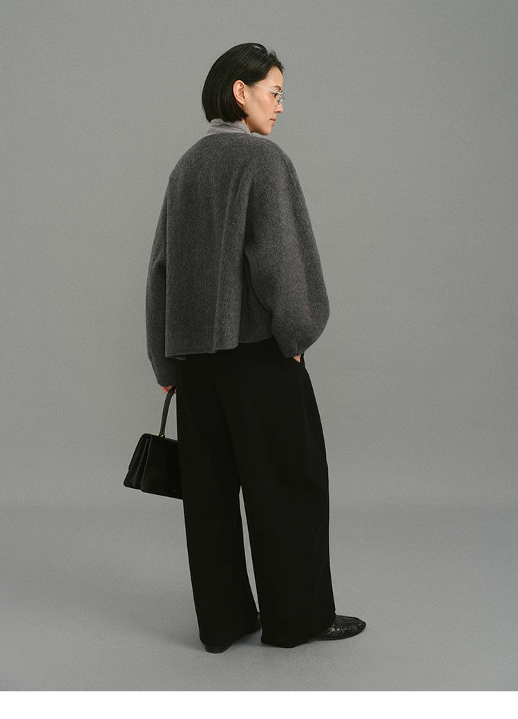 Back view showing drape and cocoon shape of charcoal wool jacket