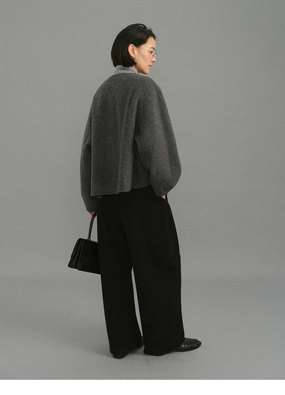Back view showing drape and cocoon shape of charcoal wool jacket