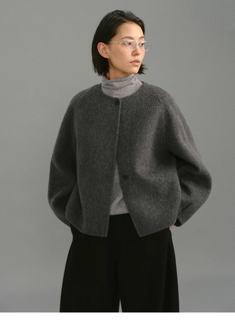 Front view of charcoal gray soft-wool cocoon jacket layered over gray turtleneck