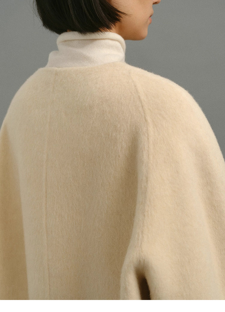 Close-up of back shoulder showing plush wool nap texture of cream cocoon jacket