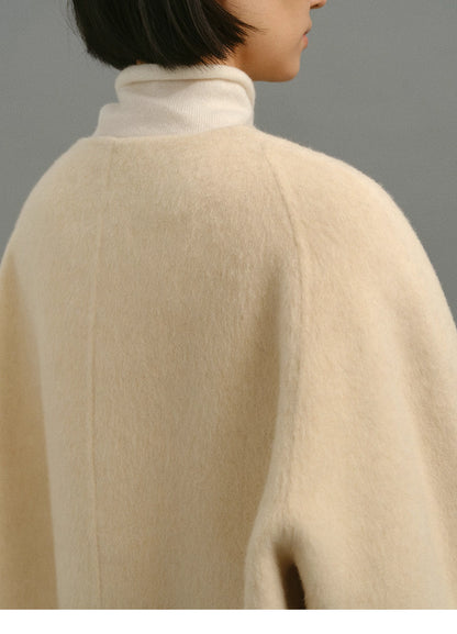 Close-up of back shoulder showing plush wool nap texture of cream cocoon jacket