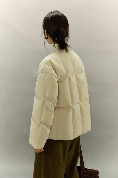 Full back view of cream beige SoftCloud lightweight down jacket with square quilt pattern and relaxed fit.