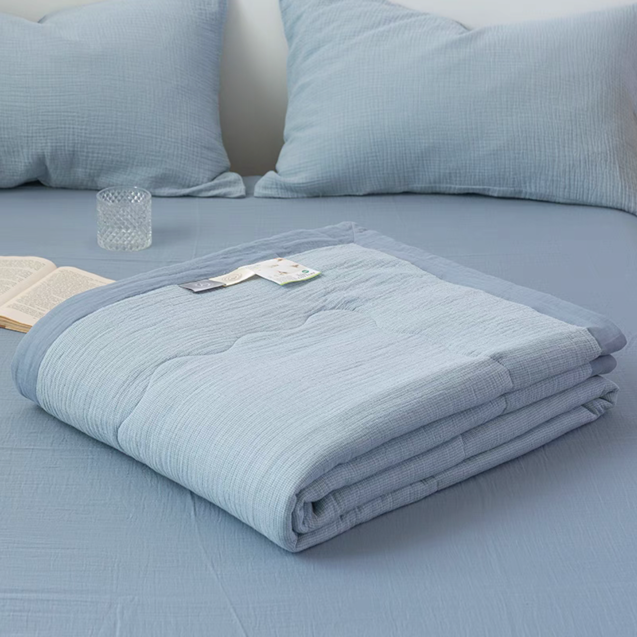Folded Light Blue SoftNest cotton muslin quilt from triple-layer bedding set showing soft breathable muslin construction