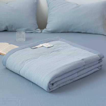 Folded Light Blue SoftNest cotton muslin quilt from triple-layer bedding set showing soft breathable muslin construction