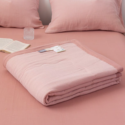 Folded Smoky Pink SoftNest cotton muslin quilt highlighting soft breathable triple-layer muslin fabric