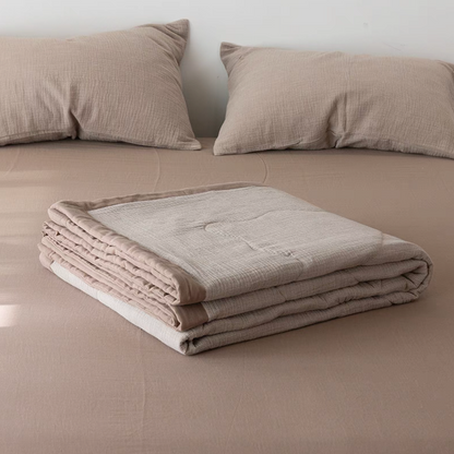 Folded Coffee color SoftNest cotton muslin quilt highlighting breathable triple-layer muslin texture