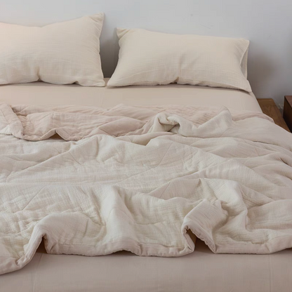 Light Yellow SoftNest triple-layer cotton muslin bedding set spread across bed with matching pillowcases