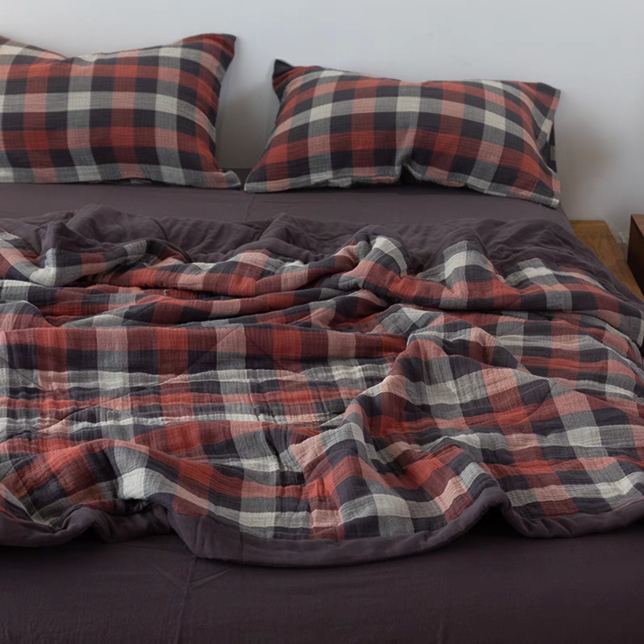 Red Black Stripes SoftNest triple-layer cotton muslin bedding set draped across bed with matching striped pillows