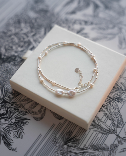 Spaced Baroque and Freshwater Pearl Sterling Silver Choker styled with matching bracelet set on display block