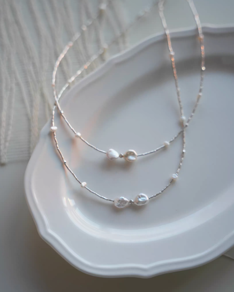 Spaced Baroque and Freshwater Pearl Sterling Silver Choker layered detail on ceramic plate highlighting baroque pearl centerpiece