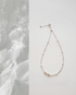 Spaced Baroque and Freshwater Pearl Sterling Silver Choker flat lay with delicate silver chain and asymmetrical pearl accents