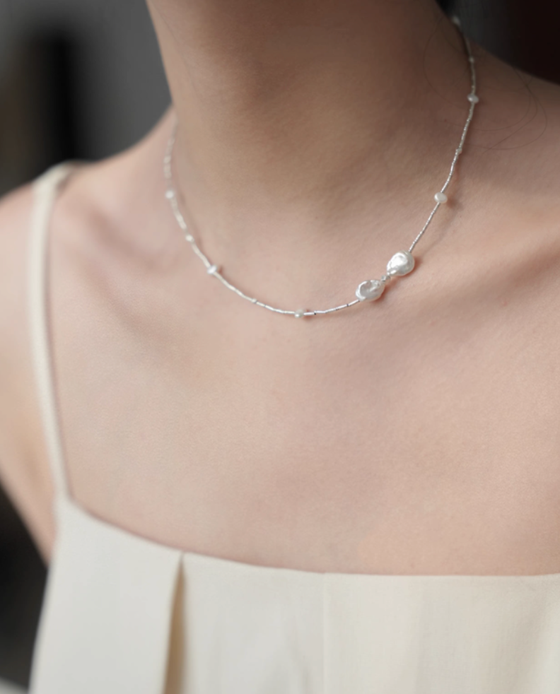 Spaced Baroque and Freshwater Pearl Sterling Silver Choker worn on neck showing minimalist silver chain and pearl accents