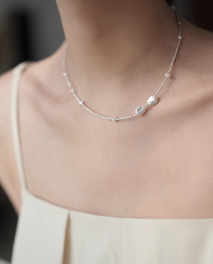 Spaced Baroque and Freshwater Pearl Sterling Silver Choker worn on neck showing minimalist silver chain and pearl accents