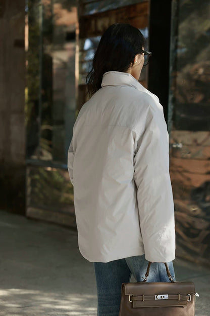 Back view of a Stone matte down jacket showing the back yoke seam and straight hem