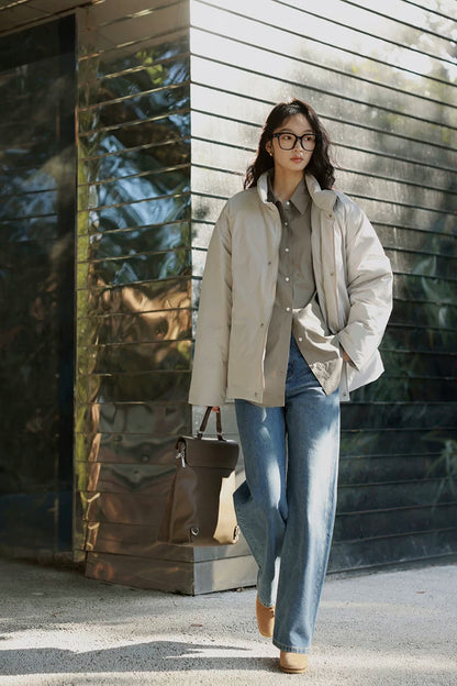 Full-length view of a Stone hip-length down jacket worn open over a shirt