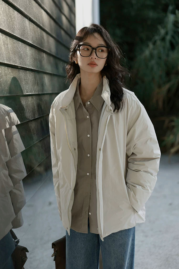 Stone matte down jacket worn open, showing the stand collar, zip front, and snap placket