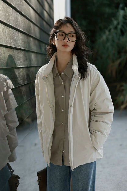 Stone matte down jacket worn open, showing the stand collar, zip front, and snap placket