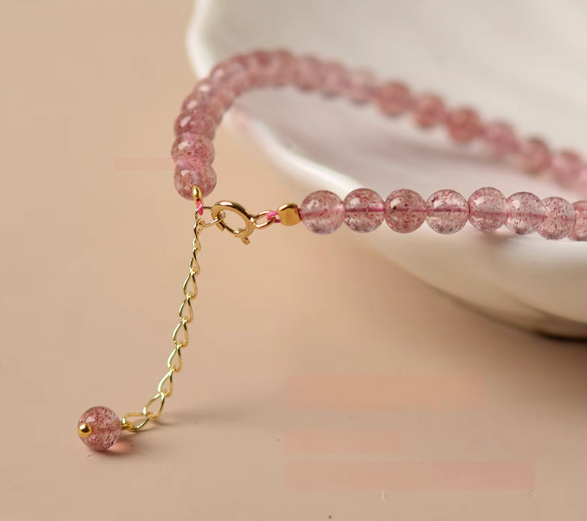 Pink strawberry quartz bracelet featuring 14K gold-filled clasp and adjustable extension chain