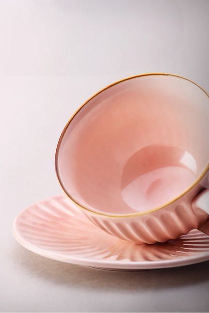 Close-up of pink striped ceramic cappuccino cup interior and saucer showing smooth glossy glaze and curved shape