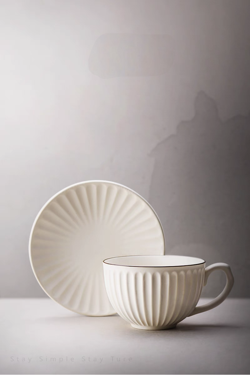 White striped ceramic cappuccino cup and saucer set in clean front view highlighting vertical ribbed texture and minimalist design