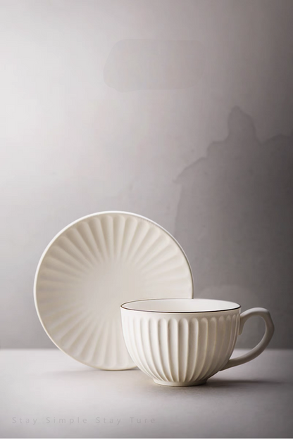 White striped ceramic cappuccino cup and saucer set in clean front view highlighting vertical ribbed texture and minimalist design