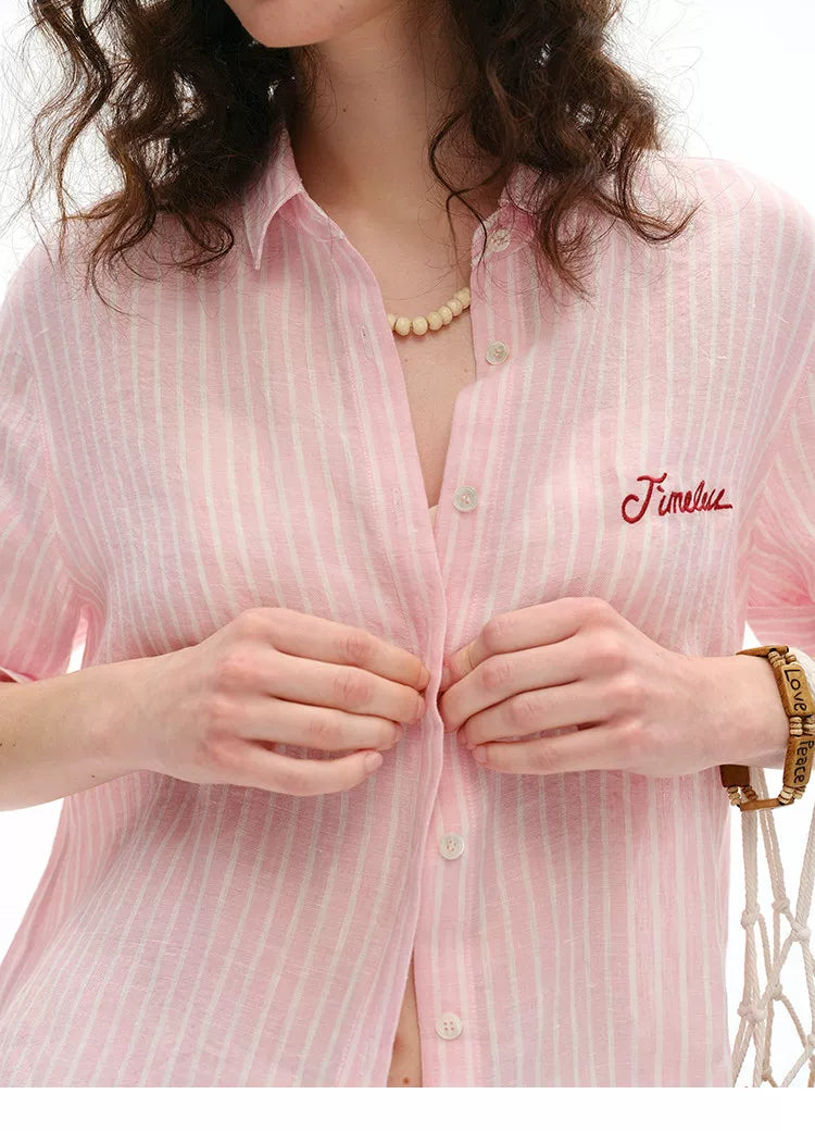 Close-up of pink striped linen shirt collar and "Timeless" embroidered detail