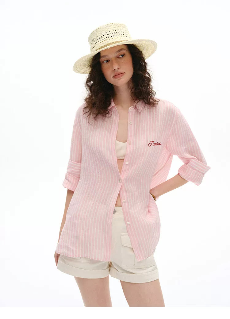Front view of pink striped linen shirt with straw boater hat