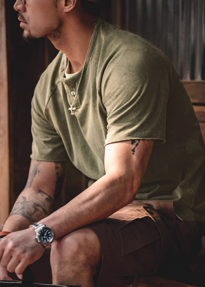 Style Washed Henley T-Shirt Green side sitting lifestyle view showing soft washed texture short sleeves and casual relaxed styling
