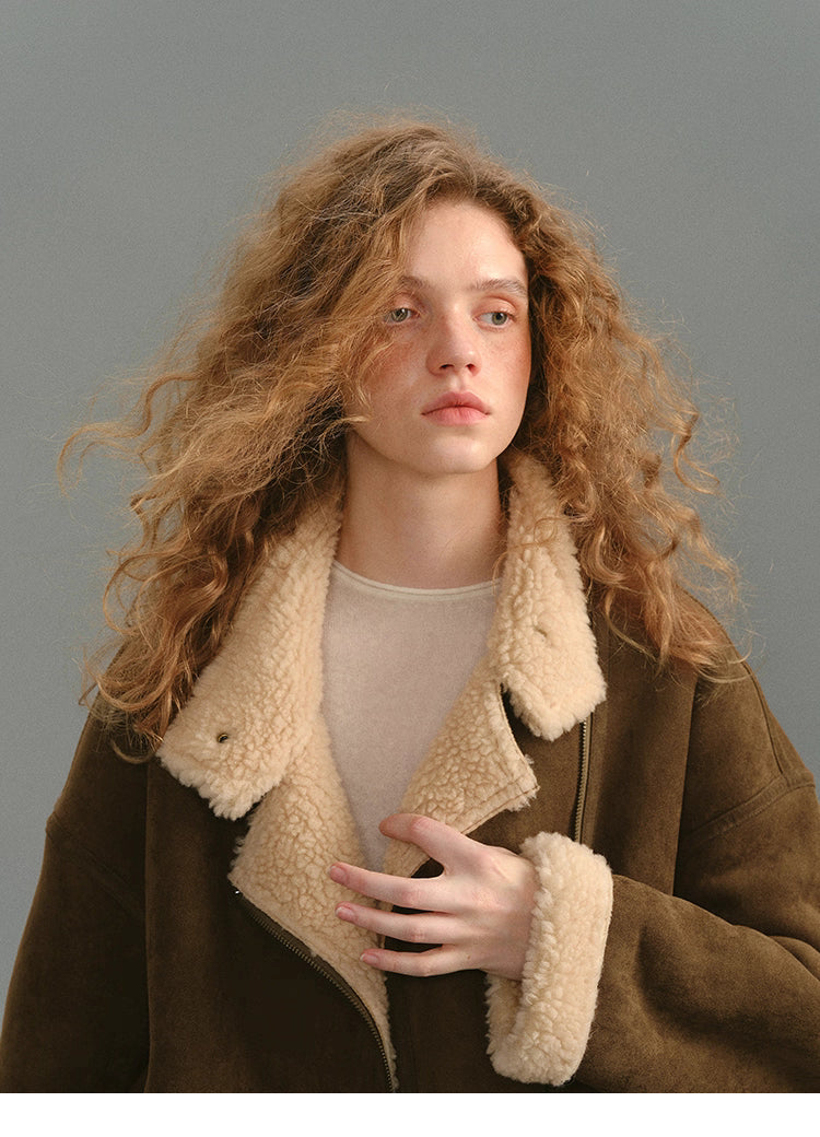 Close-up of cream shearling collar on caramel suede winter jacket.