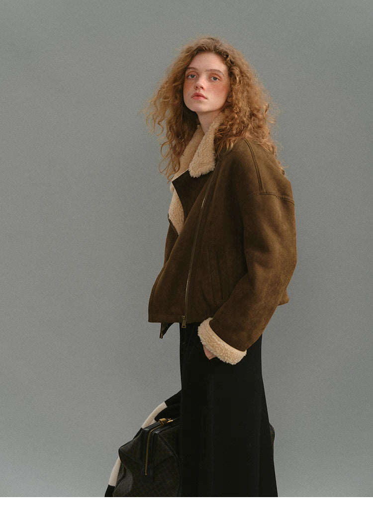 Side profile of caramel brown suede jacket with cream shearling trim.