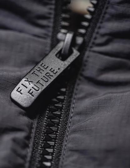 Macro view of SummitShield down jacket zipper hardware showing durable construction and high-quality fastening detail
