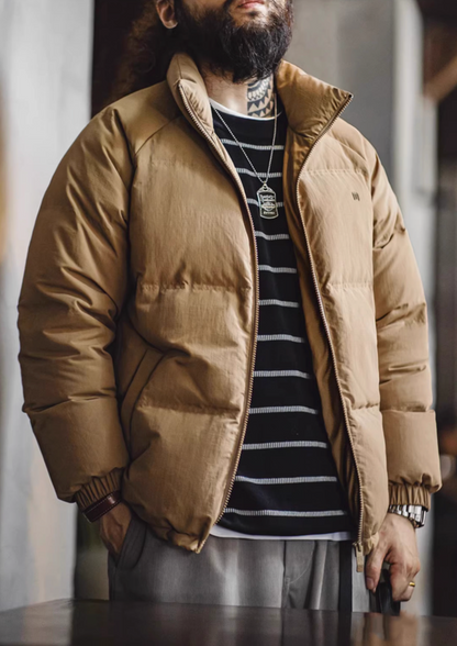Khaki SummitShield down jacket styled with striped shirt, featuring high neck collar, padded insulation, and versatile winter layering