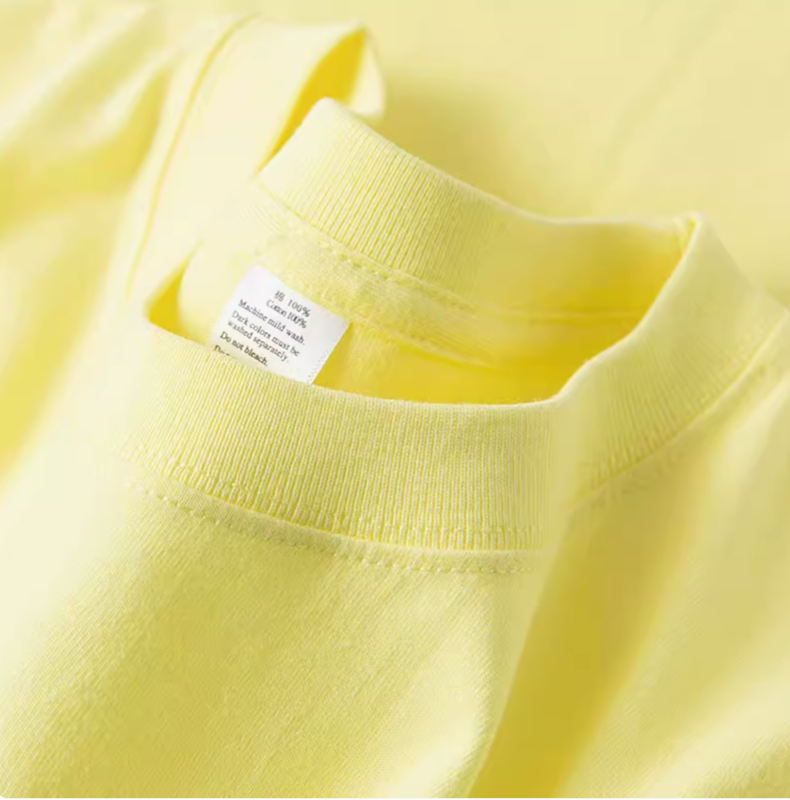 Close-up of lemon yellow cotton tee crewneck collar showing stitching and soft fabric