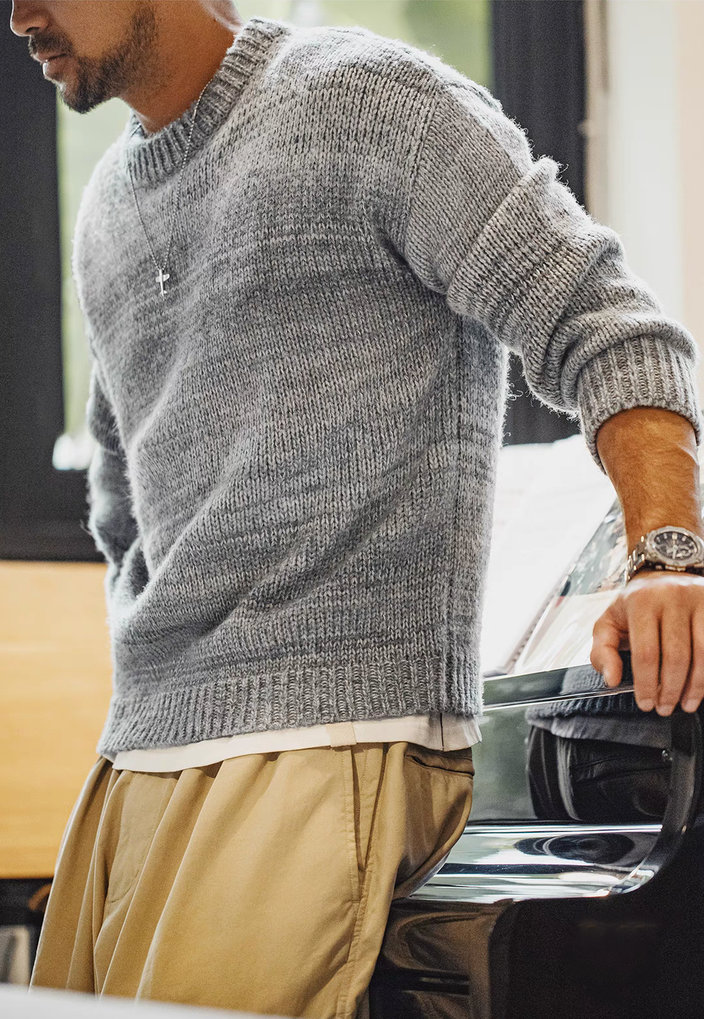 Side view of Sunset Drift Knit Sweater in Lead Grey showing ribbed cuffs soft knit texture and comfortable relaxed silhouette
