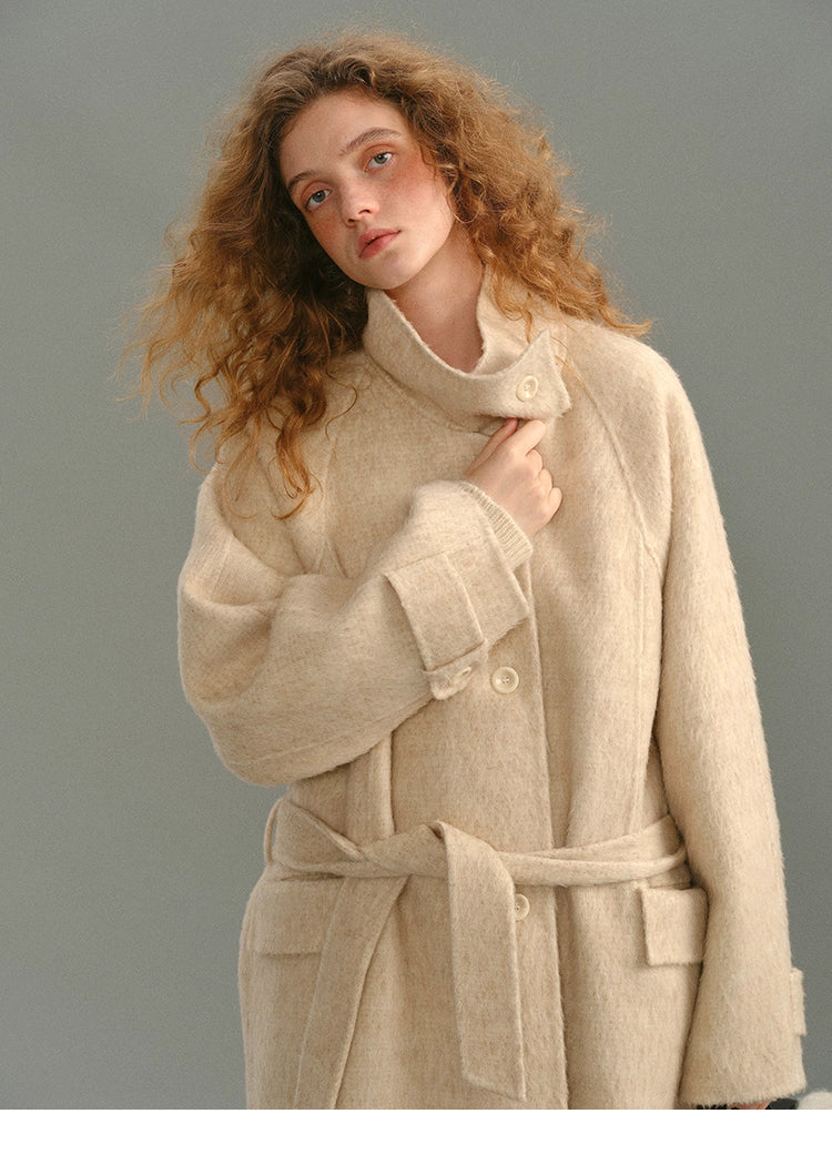 Close-up showing the sculpted stand collar and brushed alpaca-wool texture.