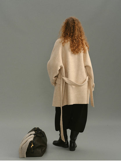 Full-body back view of the alpaca-wool wrap coat in oatmeal beige.