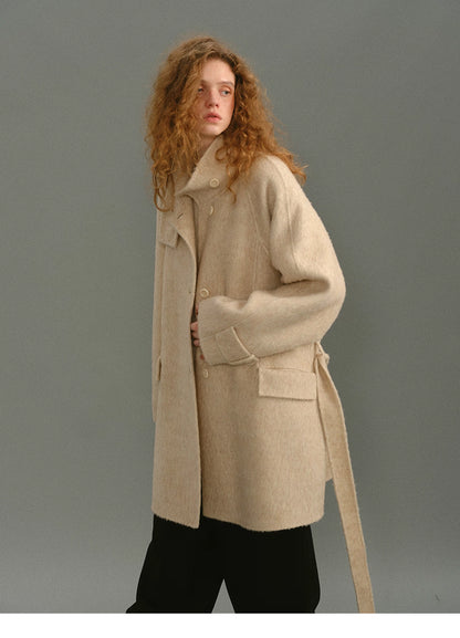 Model wearing the coat half open, showing its relaxed drape and soft shape.
